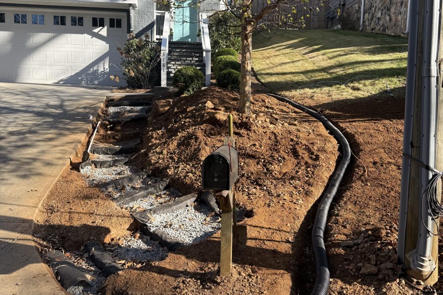A residential front yard undergoing drainage and grading work